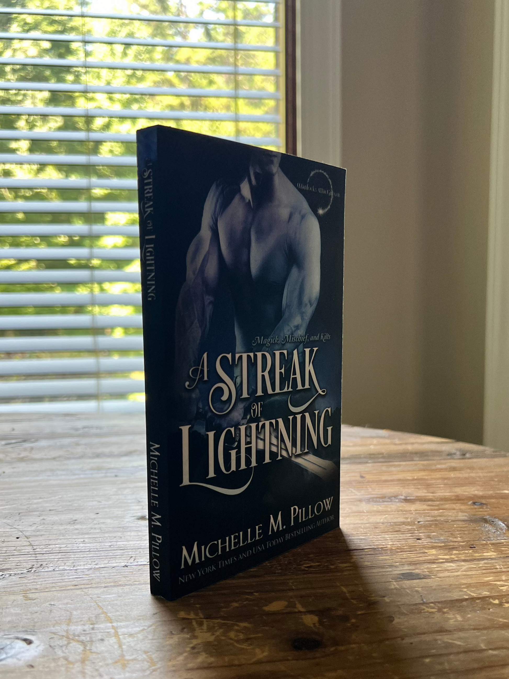 A Streak of Lightning Author Signed Paperback standing upright on a table