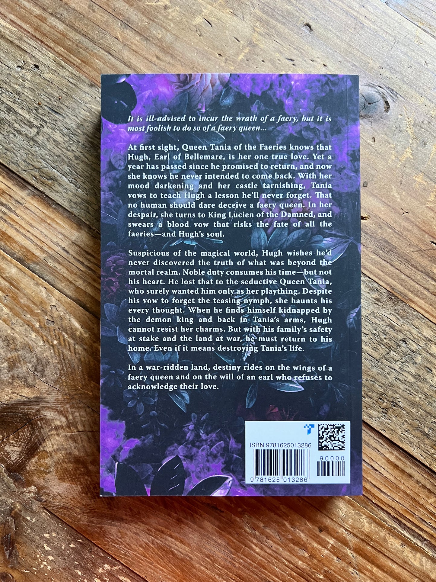 Faery Queen back cover laying on a table.