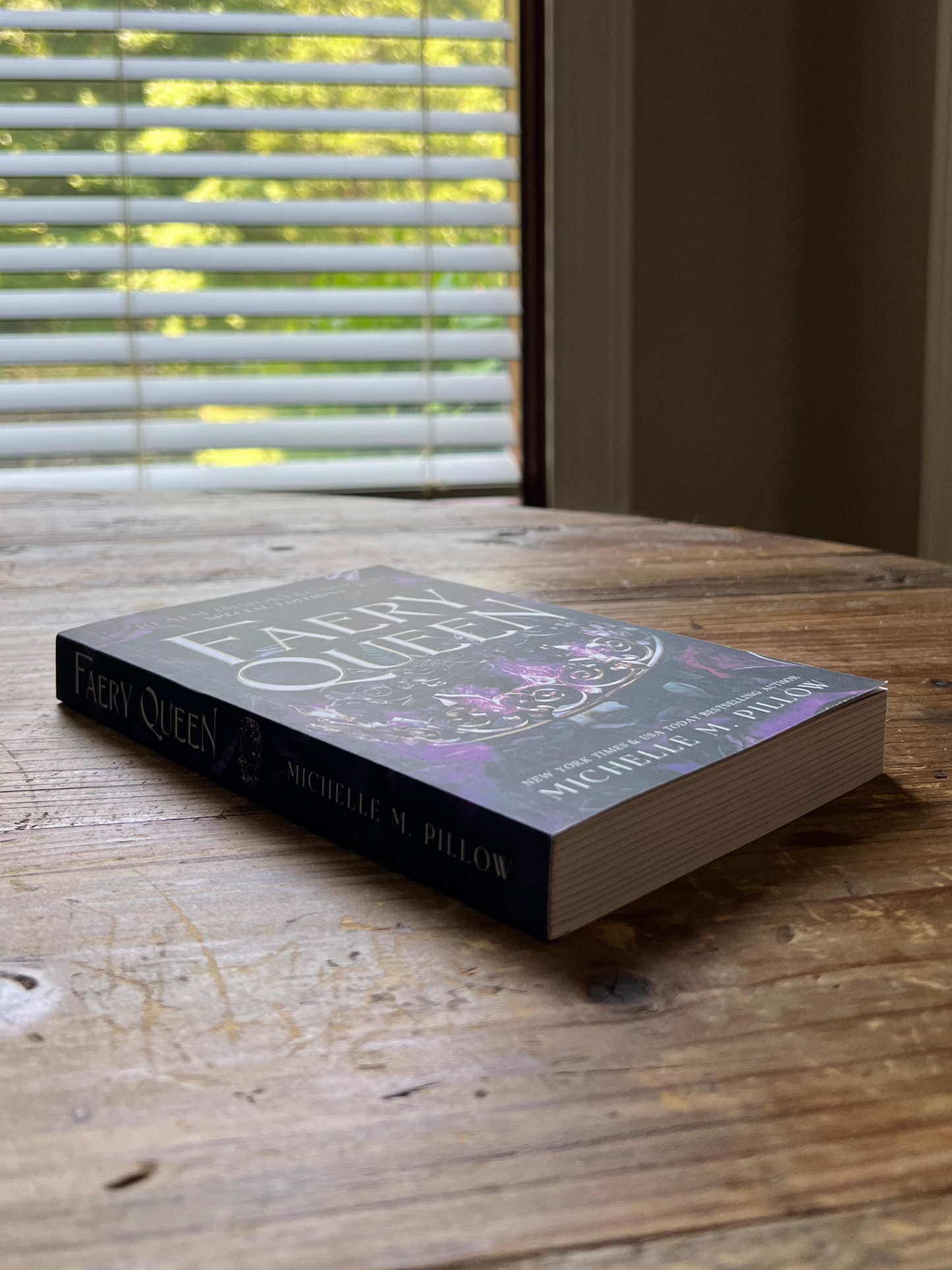 Faery Queen paperback laying on a table.