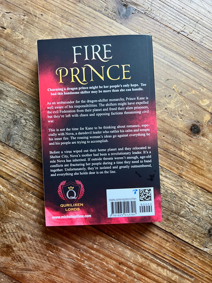 Fire Prince paperback back cover on a table.