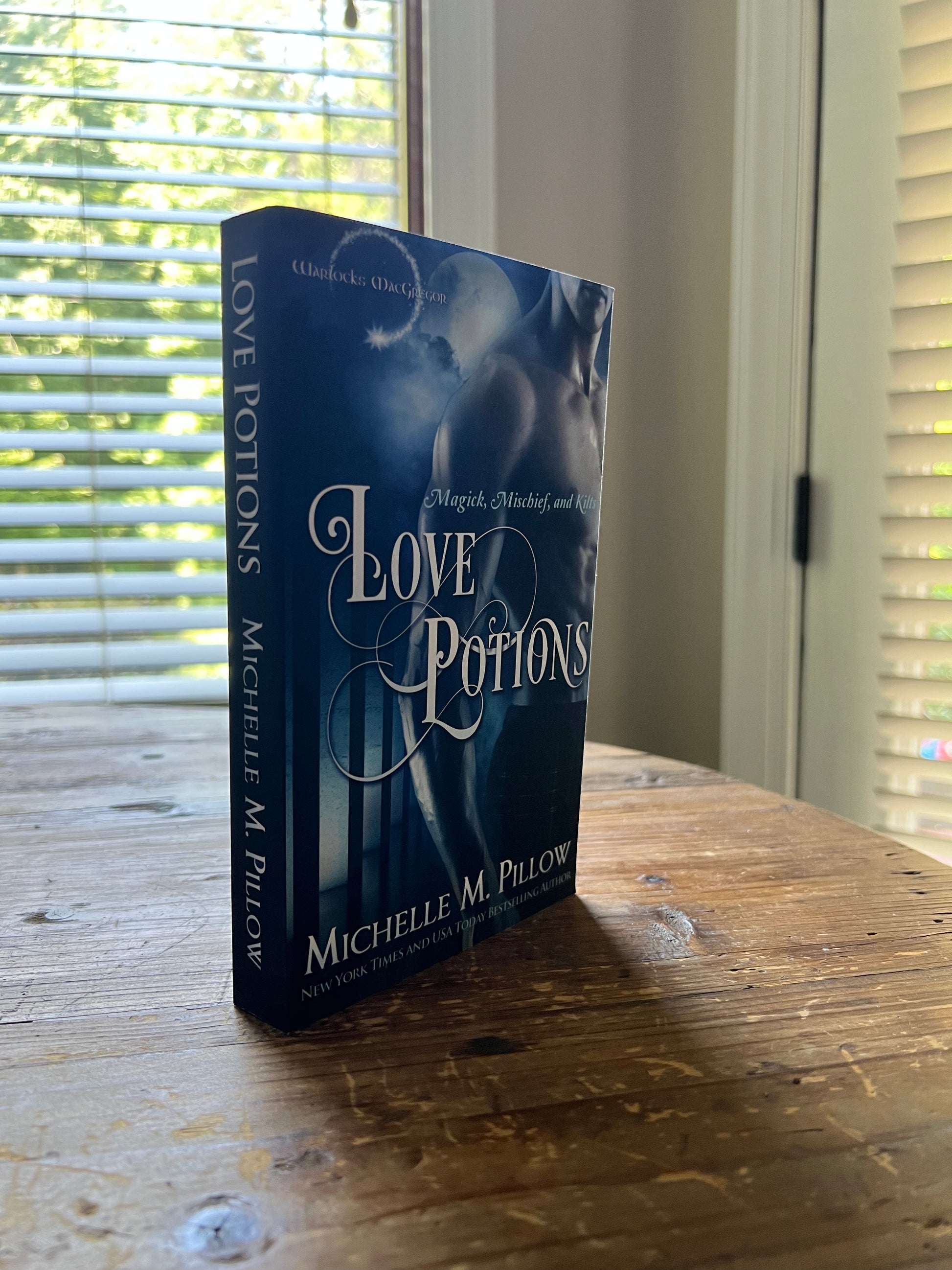  Love Potions paperback book standing upright on a table.