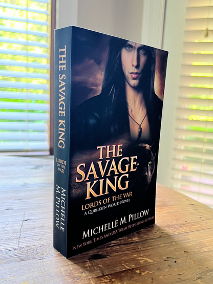 The Savage King paperback front cover upright on the table.